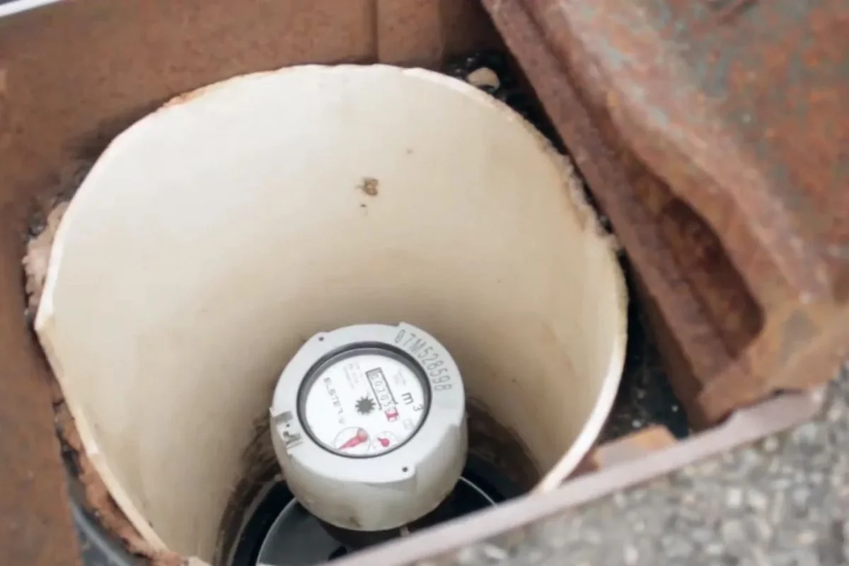 Water meter inside a meter box with its leak indicator visible